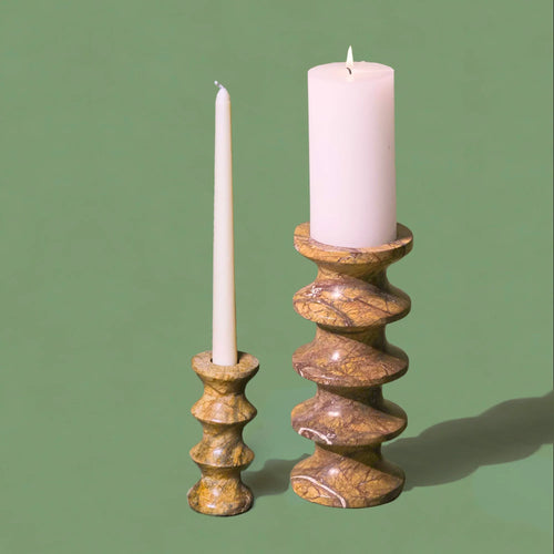 Two different sizes candlesticks with candles