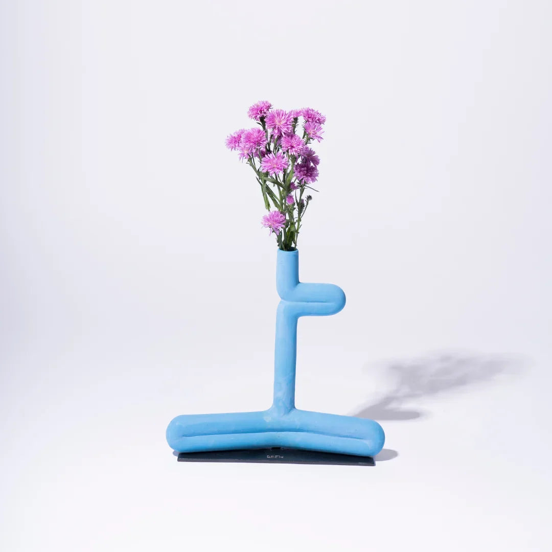 Blue inflatable vase with pink flowers on a white background